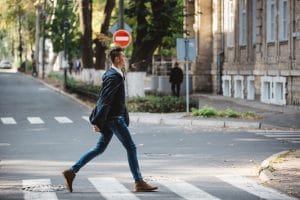 Young man cross street scaled